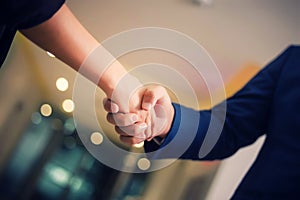 Business people shaking hands, between meeting in seminar room