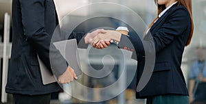 Business people shaking hands during a meeting. Two happy mature businessmen and woman