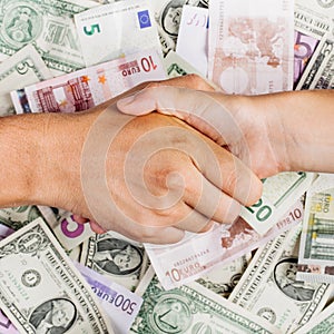 Business people shaking hands on money blur background.