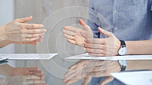 Business people shaking hands over contract agreement and financial papers at the glass table. Professional handshake