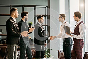 Business people shaking hands to each other