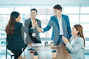 Business people shaking hands. Young modern man and woman in smart casual wear shaking hands.