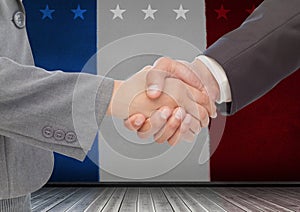 Business people shaking their hands against american flag