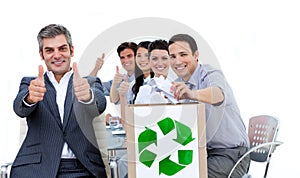 Business people showing the concept of recycling