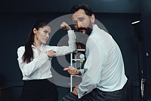 Business people showing muscles in office