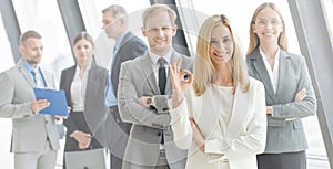 Business people showing ok sign