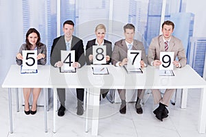 Business people showing score cards