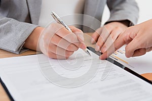 Business people signing deal contract document