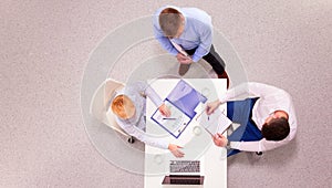 Business people sitting and discussing at business meeting, in office