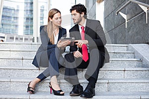 Business people sitting on a staircase