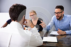 Business People Conducting Job Interview Looking At Applicant photo