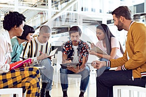 Business people sitting together and having group discussion in office