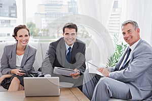 Business people smiling at camera while having a meeting