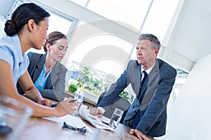 Business people speaking together during meeting