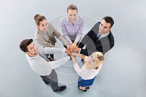 Business people stacking hands
