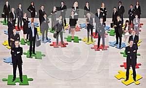 Business people standing on jigsaw pieces