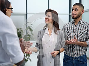 Business people standing and shaking hands in an office building