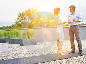 Business people standing while talking in office rooftop during break