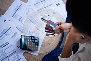 Business people are stressed about credit card debt and many bills on the floor.