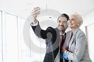 Business people taking selfie in convention center