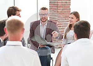 Business people talk at a group meeting in a circle.