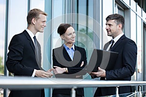 Business people talking in front of office building