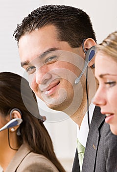 Business people talking on headsets