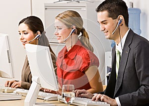 Business people talking on headsets