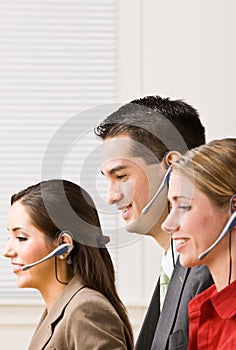 Business people talking on headsets