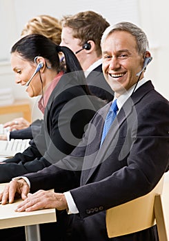 Business people talking on headsets