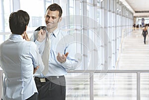 Business people talking in office lobby