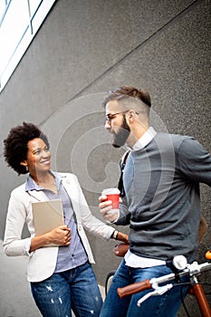 Business people talking outside company with holding coffee break time concept.