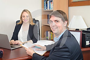 Business people talking over laptop at the table