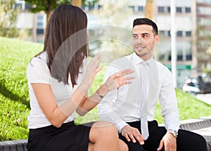 Business people talking while sitting outdoor