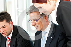 Business people - team meeting in an office