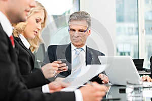 Business people - team meeting in an office