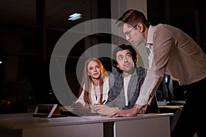 Business people team working late night using computer. Overtime hours concept.