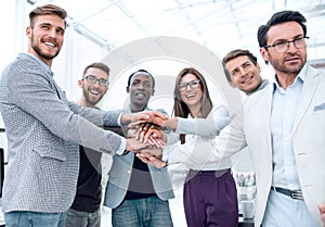 Business People teamwork stacking hands showing unity
