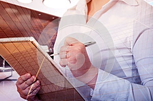 Business, people and technology concept - double exposure businesswoman with notebook over city background