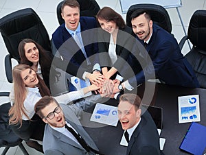 Business people with their hands together in a circle