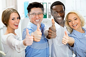 Business people with thumbs up