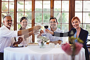 Business people toasting wine glasses in restaurant