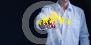 Business people are touching the virtual screen on the star icon to show satisfaction with service. Customer service and