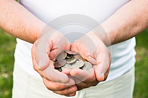 Business people use two hands to hold a lot of coins, costs and planning concept photo