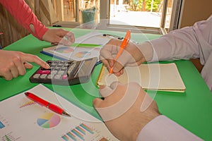 Business people are using calculator to work. Young Business people Calculating Finance Bills In Office