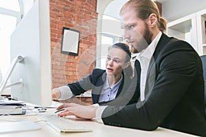 Business people using computer in office