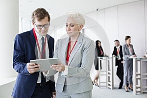 Business people using digital tablet in convention center