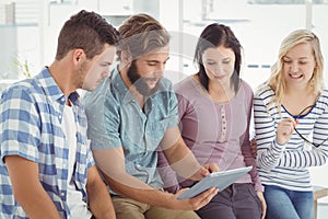 Business people using digital tablet at desk