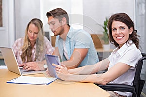 Business people using digital tablet and laptop in meeting