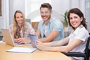 Business people using digital tablet and laptop in meeting